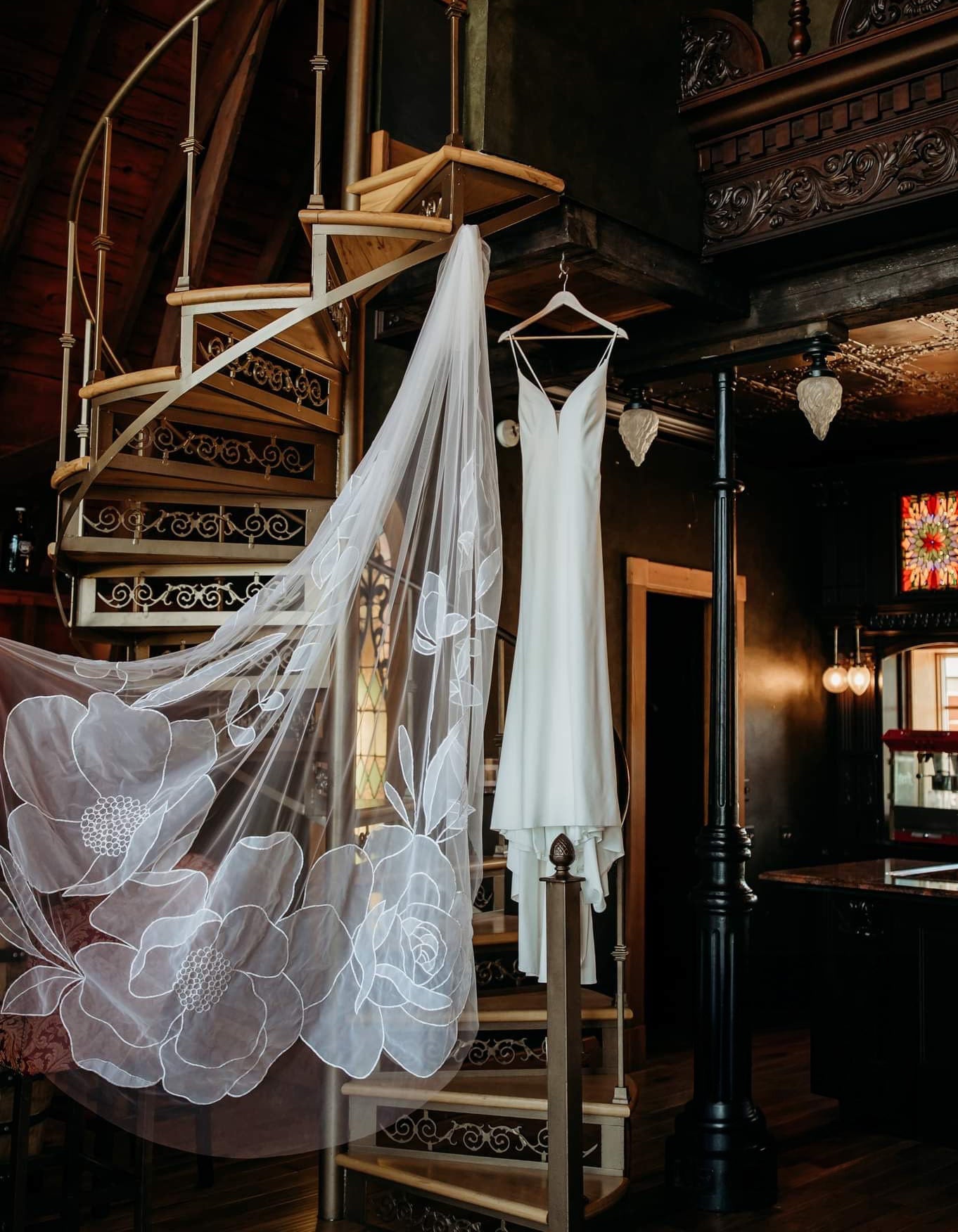 wedding dress hanging on a spiral staircase